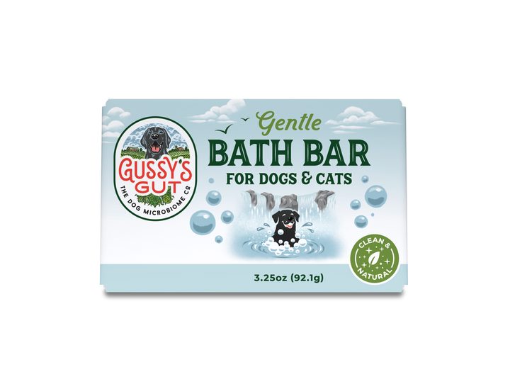 Organic dog and cat bath bar in light blue packaging with a playful illustration of a dog bathing under waterfalls, labele...