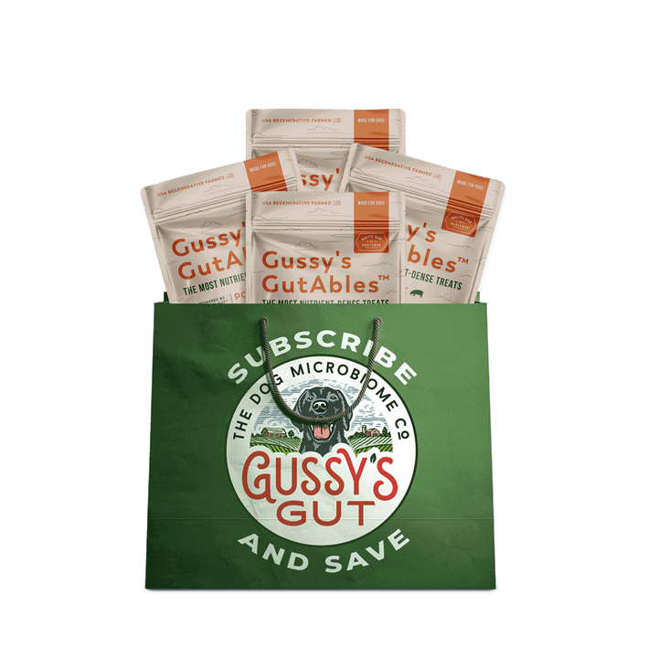 Green Gussy's Gut bag with dog treats on a white background