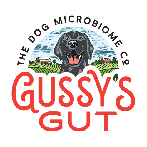 Logo featuring a black dog with open mouth, green farm landscape, and red text "Gussy’s Gut" for organic dog supplements.