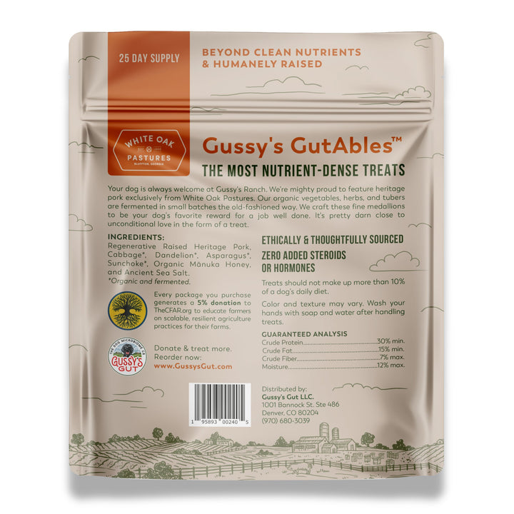 Gussy's GutAbles™ Treats packaging featuring White Oak Pastures pork, with farm landscape illustration and product details.