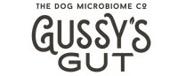 Organic fermented dog supplement in a brown jar with a white label, featuring green accents and Gussy’s Gut logo.